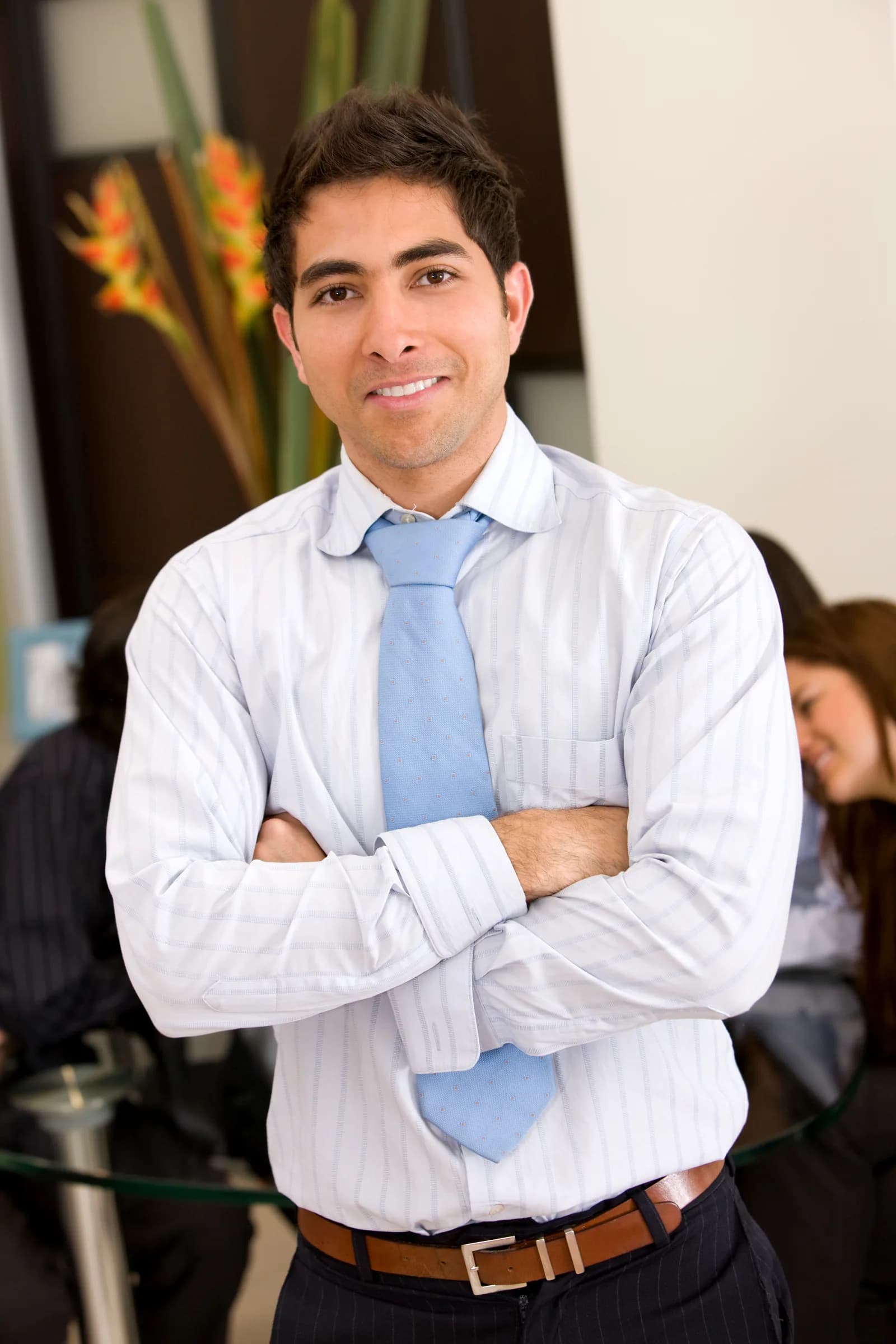 Young professional with crossed arms in an office